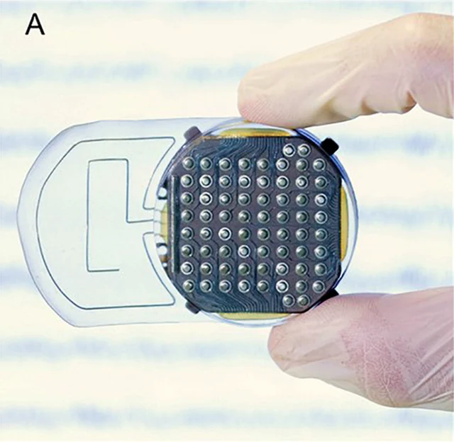 Photograph of a WIMAGINE implant with its circular 64-contact electrode face and flat antenna extension.
